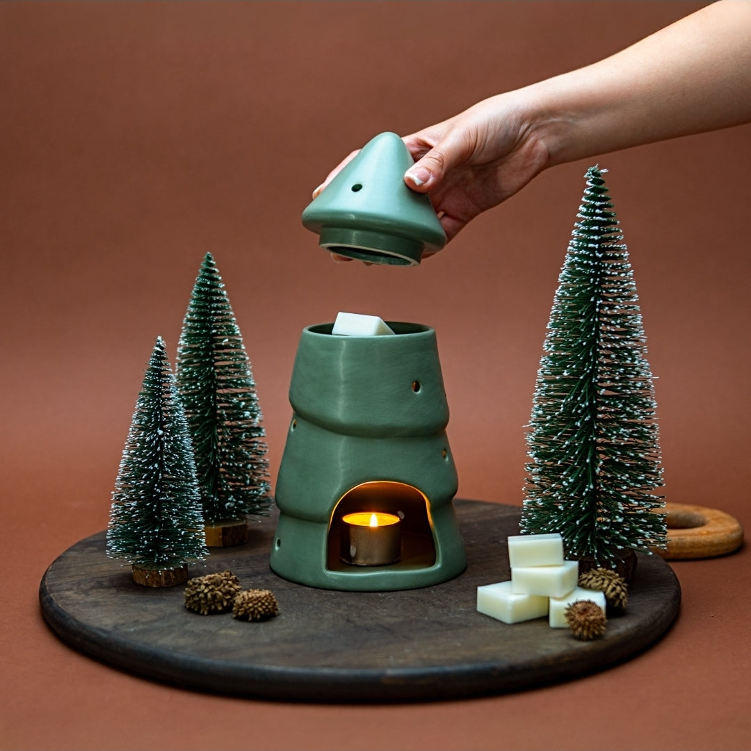Matte sage green ceramic Christmas tree wax melt burner with cut-out detail by Clyne's Candles