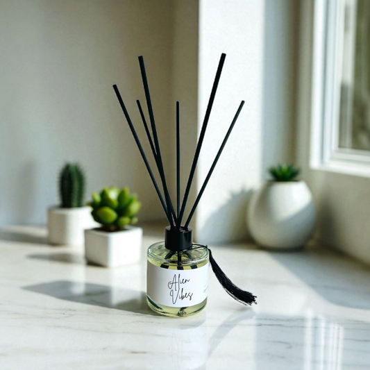Perfume-inspired reed diffuser with clear glass bottle and fibre reeds handmade by Clyne's Candles.