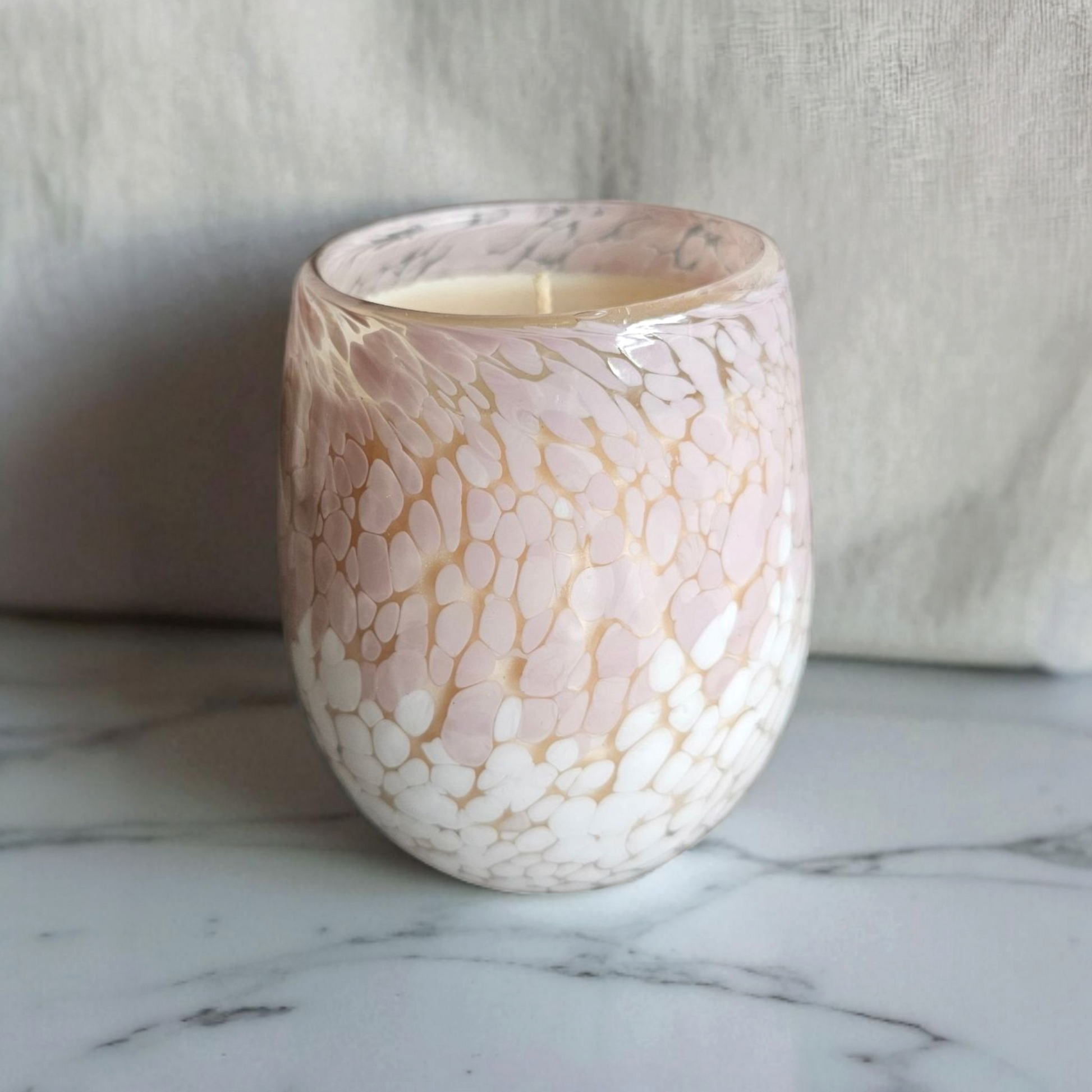 Beautiful hand poured coconut soy candle in a pink pebble print glass handmade by Clyne's Candles in Kirriemuir, Scotland