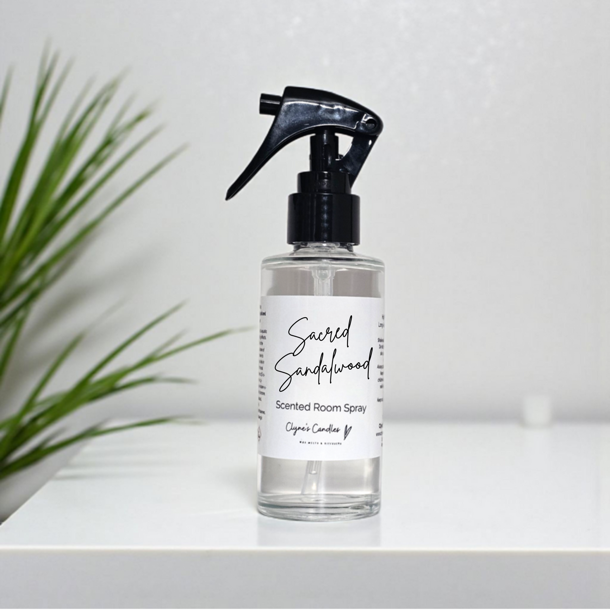 Handmade glass bottle room spray with mini mist trigger in Sacred Sandalwood fragrance – creamy sandalwood with soft spice and citrus, highly scented and long-lasting by Clyne’s Candles.