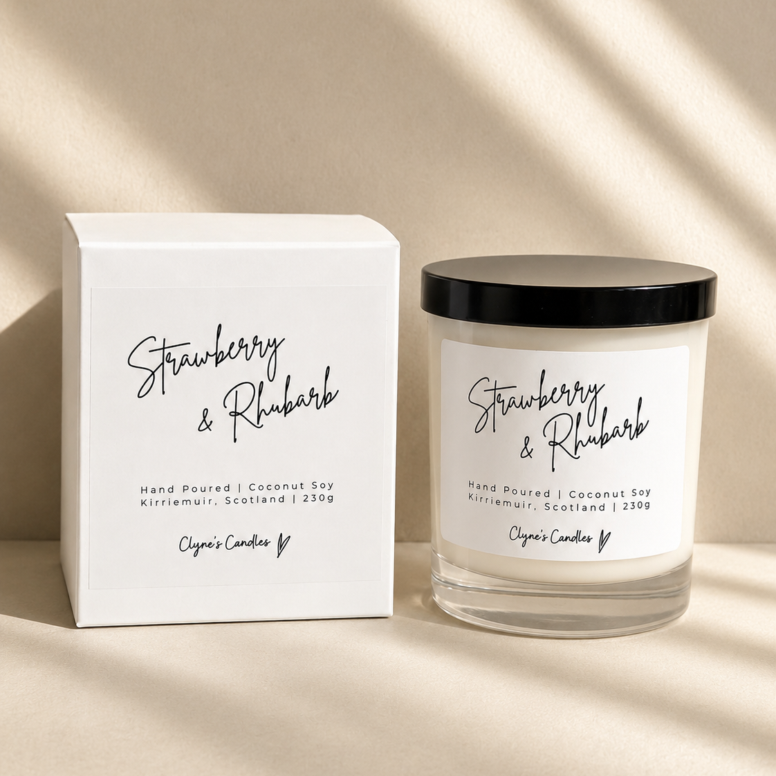 Strawberry & Rhubarb scented coconut soy candle with a black lid and gift box, handmade by Clyne's Candles in Kirriemuir, Scotland