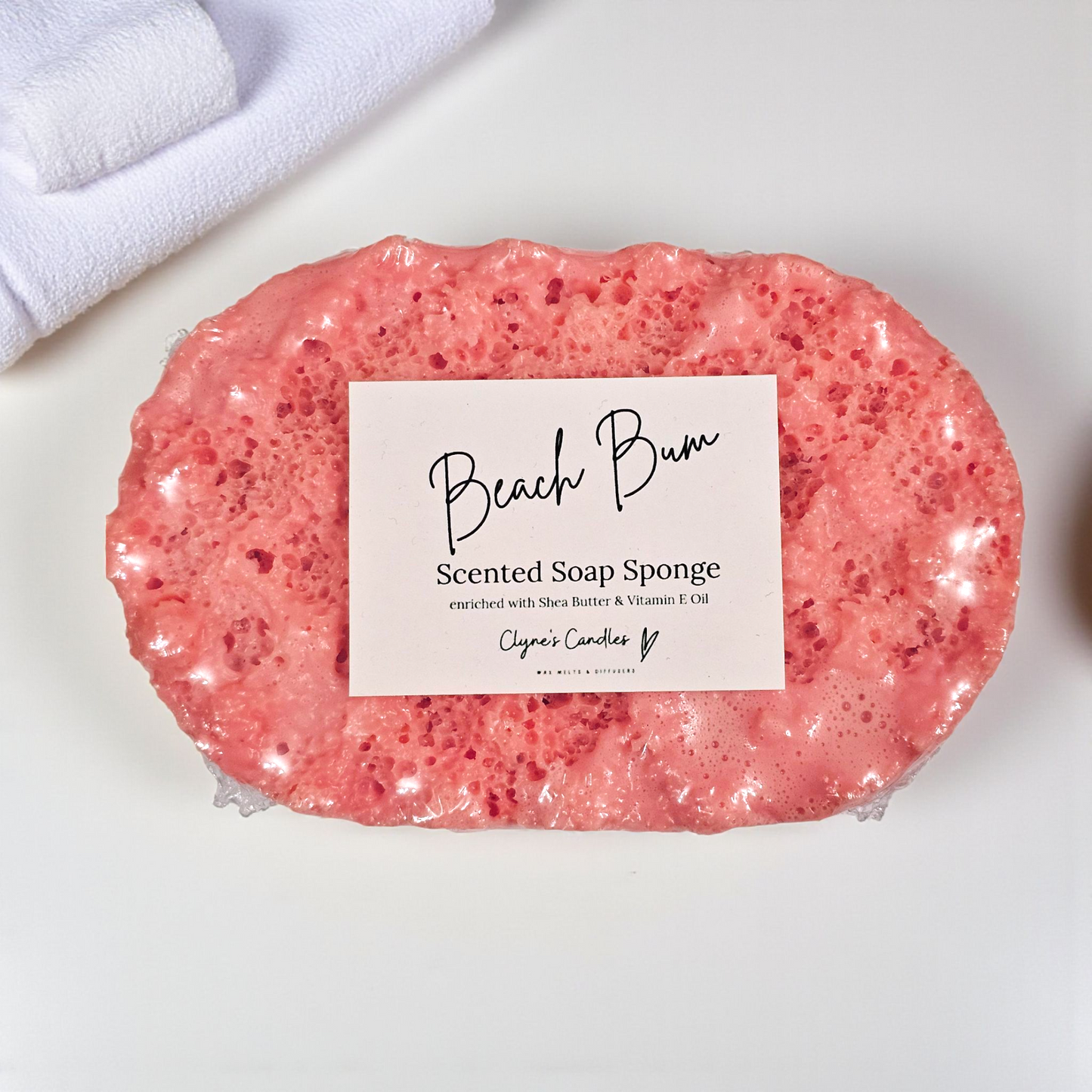 Beach Bum soap sponge by Clyne’s Candles, a 2-in-1 exfoliating sponge infused with tropical coconut and summer-inspired Beach Bum fragrance, enriched with shea butter for soft, nourished skin, handmade in Kirriemuir