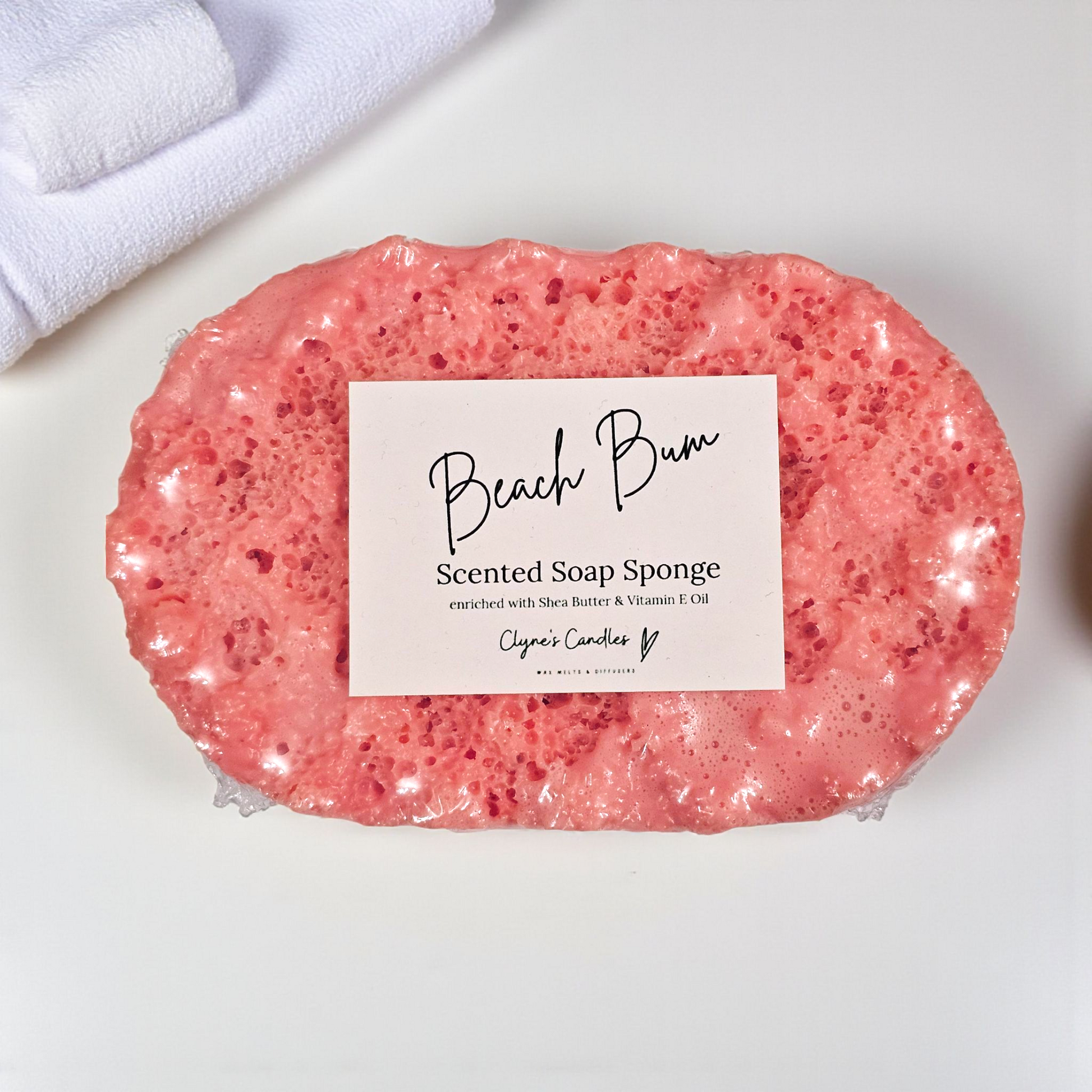 Beach Bum soap sponge by Clyne’s Candles, a 2-in-1 exfoliating sponge infused with tropical coconut and summer-inspired Beach Bum fragrance, enriched with shea butter for soft, nourished skin, handmade in Kirriemuir