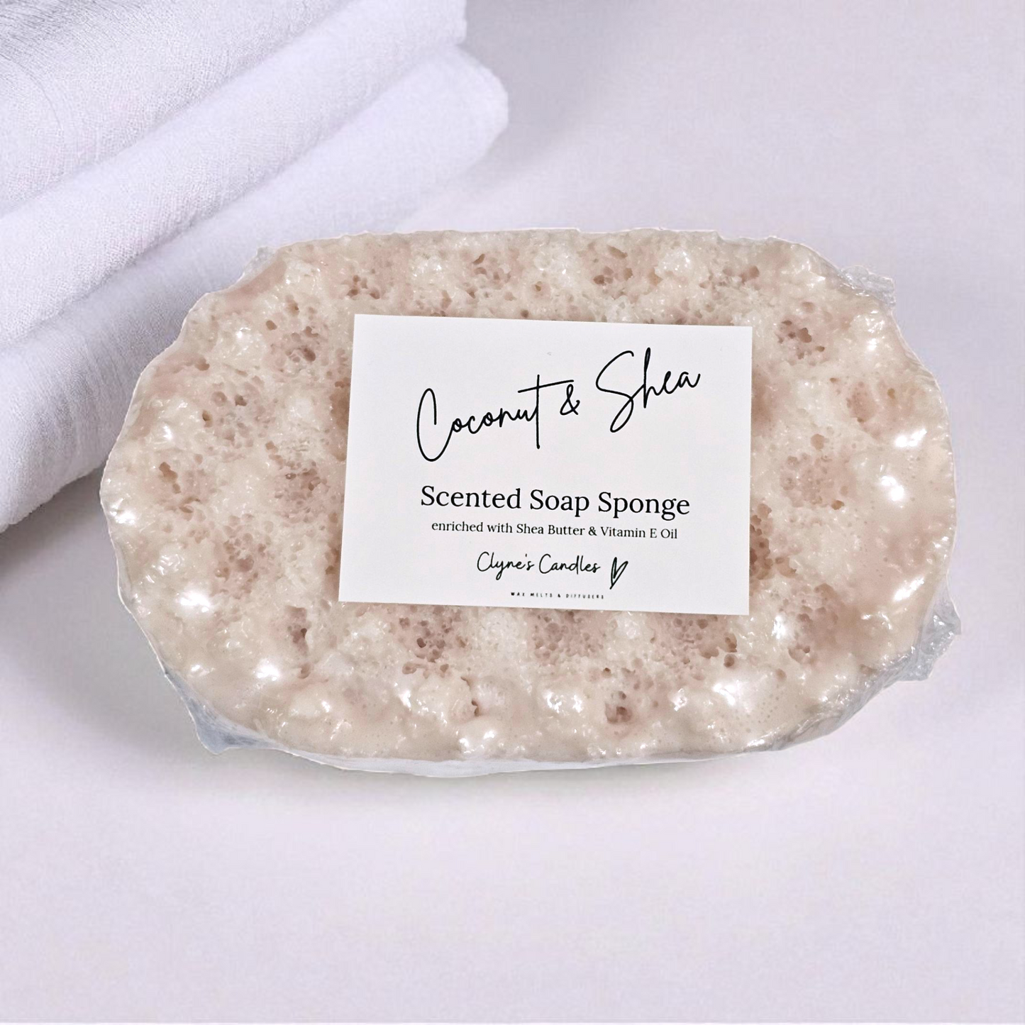 Coconut and Shea soap sponge by Clyne’s Candles, a nourishing 2-in-1 exfoliating sponge infused with creamy coconut fragrance and enriched with moisturising shea butter for soft, smooth skin.