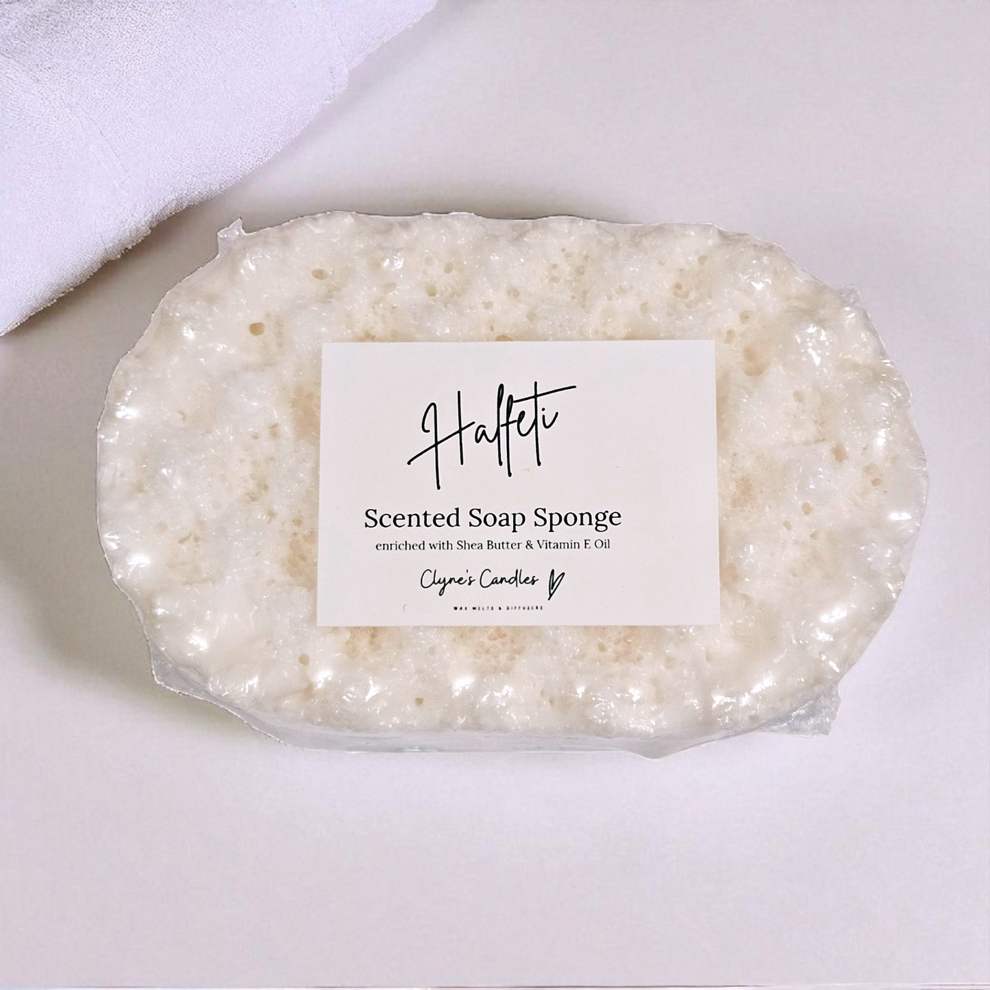 Halfeti soap sponge with added shea butter by Clyne’s Candles, a 2-in-1 exfoliating sponge infused with luxury Halfeti fragrance — oud, rose and dark woods — while nourishing the skin with moisturising shea butter
